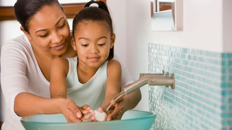 mother and daughter using the sink